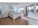 Spacious main bedroom with a king-size bed and sliding glass doors to balcony at 601 Shreve St # 51B, Punta Gorda, FL 33950