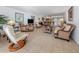 Open living room with kitchen view, wicker furniture, tile floors at 601 Shreve St # 51B, Punta Gorda, FL 33950