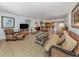 Open and bright living room with tile floors and wicker furniture at 601 Shreve St # 51B, Punta Gorda, FL 33950