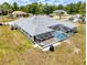 Aerial view showing home with pool and screened enclosure at 5366 Hader Rd, North Port, FL 34288