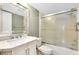 This bathroom features a marble vanity, large mirror, and a shower/tub combo with sliding glass doors at 756 White Pine Tree Rd # 204, Venice, FL 34285