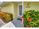 Inviting front door entrance with colorful landscaping at 16478 Gloria Ln # 208, Nokomis, FL 34275