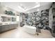 Spa-like bathroom boasts a large soaking tub and separate shower with marble tile at 2340 Bayshore Rd, Nokomis, FL 34275