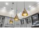 Three gold pendant lights hang above the kitchen island at 2340 Bayshore Rd, Nokomis, FL 34275