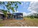 A screened in in-ground pool and deck area for entertaining with a view of the backyard at 1061 Owl Dr, Englewood, FL 34223