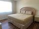 Primary bedroom with a king-size bed and wood flooring at 519 Albee Farm Rd # 317, Venice, FL 34285
