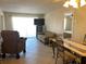 Living room features a sofa, dining set, and access to a balcony at 519 Albee Farm Rd # 317, Venice, FL 34285