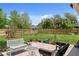 Lush backyard featuring a patio, seating, and well-manicured lawn with established landscaping at 566 Viridian St, Englewood, FL 34223
