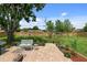 Spacious backyard featuring a paver patio, seating area, and a well-maintained lawn at 566 Viridian St, Englewood, FL 34223
