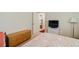 Bedroom with neutral carpet featuring a bed with a floral quilt, and access to other rooms at 566 Viridian St, Englewood, FL 34223