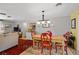 A warm dining area with a farmhouse-style table and cozy seating, creating a welcoming atmosphere for meals at 566 Viridian St, Englewood, FL 34223