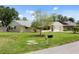 A beautifully maintained single-story home with a well-kept lawn, a driveway, and a classic mailbox on a sunny day at 566 Viridian St, Englewood, FL 34223