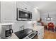 Close-up of a modern kitchen with sleek appliances, marble countertops, and stylish white cabinetry, perfect for cooking at 566 Viridian St, Englewood, FL 34223