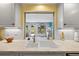 Kitchen with a sunny view to the outdoor space through the Florida room window at 566 Viridian St, Englewood, FL 34223