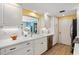 Bright white kitchen with new appliances, light countertops, and view into the Florida room at 566 Viridian St, Englewood, FL 34223