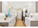 Modern kitchen featuring white cabinets, quartz countertops, and stainless steel appliances, designed for culinary enthusiasts at 566 Viridian St, Englewood, FL 34223