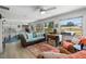 Inviting living area with comfortable seating, a large rug, and sun-filled windows creating a warm ambiance at 566 Viridian St, Englewood, FL 34223