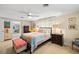 Well-lit bedroom featuring comfortable furnishings, neutral tones, and access to the living room at 566 Viridian St, Englewood, FL 34223