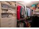 Organized walk-in closet with ample hanging space, shelving, and drawer storage for clothing and accessories at 566 Viridian St, Englewood, FL 34223