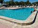 Community pool with people enjoying a relaxing swim at 5220 Palena Blvd, North Port, FL 34287