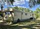 Mobile home with long side yard and mature trees at 5220 Palena Blvd, North Port, FL 34287