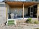 Covered patio with wicker furniture and green steps at 5220 Palena Blvd, North Port, FL 34287