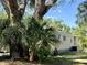 Side view of mobile home nestled amongst lush greenery at 5220 Palena Blvd, North Port, FL 34287