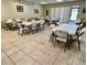 Large community room with multiple tables and chairs at 5220 Palena Blvd, North Port, FL 34287