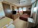 Cozy bedroom with wood paneling and a comfortable bed, dresser, and television at 5220 Palena Blvd, North Port, FL 34287