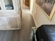 Hallway with wood-look flooring and a decorative cabinet at 5220 Palena Blvd, North Port, FL 34287