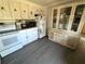 Kitchen with gray floor and white appliances and cabinets at 5220 Palena Blvd, North Port, FL 34287