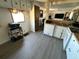 Kitchen with dishwasher, sink, gray vinyl floor and upper cabinets at 5220 Palena Blvd, North Port, FL 34287