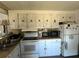 Kitchen with white appliances, upper cabinets, and countertop appliances at 5220 Palena Blvd, North Port, FL 34287