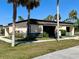Exterior view of community building with palm trees and landscaping at 5220 Palena Blvd, North Port, FL 34287