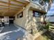 Tan mobile home with covered carport and landscaping at 5220 Palena Blvd, North Port, FL 34287