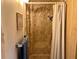 Bathroom shower with a marble-patterned surround and curtain at 5220 Palena Blvd, North Port, FL 34287