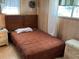 Simple bedroom with a double bed and wood nightstands at 5220 Palena Blvd, North Port, FL 34287