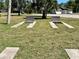 Two shuffleboard courts are situated on a grassy area with palm trees nearby at 5220 Palena Blvd, North Port, FL 34287