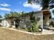 Tan mobile home with covered carport and latticework accents at 5220 Palena Blvd, North Port, FL 34287