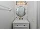 Small bathroom with modern vanity and round mirror at 14462 Fort Worth Cir, Port Charlotte, FL 33981