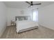 King-size bed in a spacious bedroom with ceiling fan and natural light at 14462 Fort Worth Cir, Port Charlotte, FL 33981