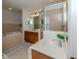 Bathroom features a soaking tub, walk-in shower, and double vanity at 14462 Fort Worth Cir, Port Charlotte, FL 33981