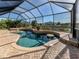 Relaxing screened pool with spa and water feature, surrounded by pavers at 14462 Fort Worth Cir, Port Charlotte, FL 33981