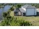 Aerial view of a house with a pool and screened lanai overlooking the water at 14462 Fort Worth Cir, Port Charlotte, FL 33981