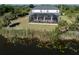 An aerial view of a home with a screened-in pool and lanai at 14462 Fort Worth Cir, Port Charlotte, FL 33981