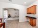 Kitchen with built-in desk and view into living room at 14462 Fort Worth Cir, Port Charlotte, FL 33981