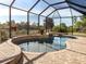 Inviting screened pool and spa with a water feature at 14462 Fort Worth Cir, Port Charlotte, FL 33981