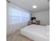 Bright bedroom with a queen bed, workspace, and sheer curtains at 14462 Fort Worth Cir, Port Charlotte, FL 33981