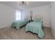 Bedroom with twin beds and light, airy decor at 14462 Fort Worth Cir, Port Charlotte, FL 33981