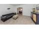 Open living room with leather sofa and view into dining area at 14462 Fort Worth Cir, Port Charlotte, FL 33981